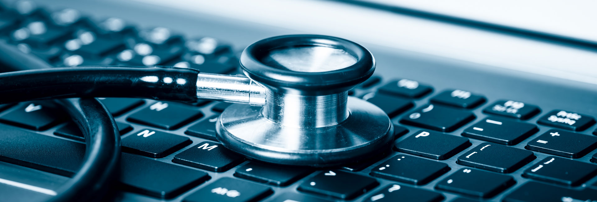 stethoscope on keyboard - tech solutions and computer health check